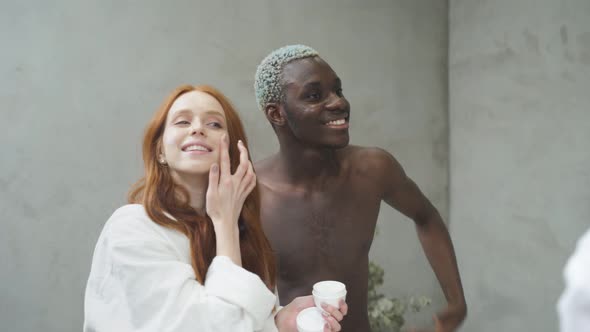 Attractive Multiethnic Couple After Morning Shower Enjoy Beauty Procedures