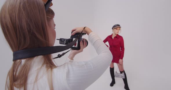 Girl Photographer Makes Shots With A Model In A Photo Studio