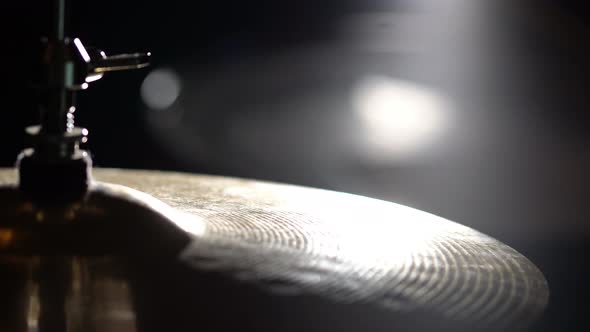 Hands of musician drummer holding drum sticks hitting on hi-hat cymbal