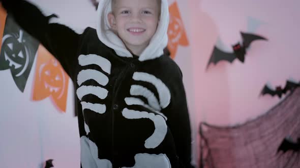 Halloween Kids Happy Dancing Boy in Halloween Skeleton Costume at Home alt