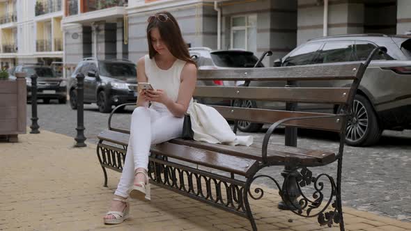 Young Woman Uses Smartphone