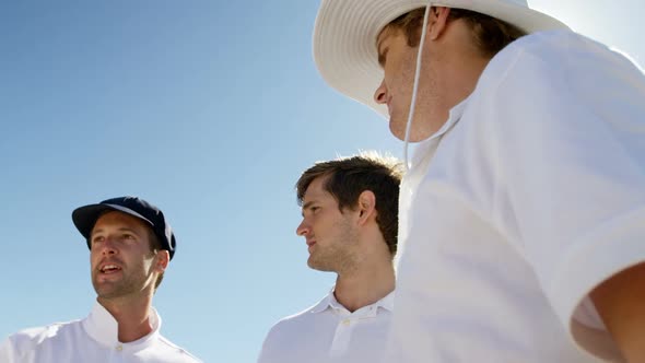 Cricket players into team discussion during cricket match alt