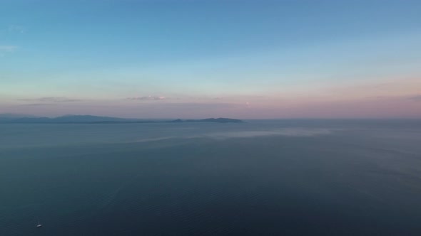 Sunset in Mesologgi Greece. Aerial view of the sunset behind clouds and sea horizon. alt