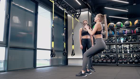 Slim Girlfriends Doing Workout with TRX System alt