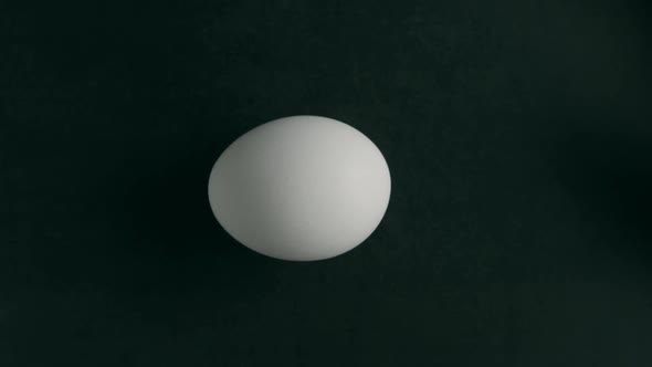 A White Egg Is Spinning on the Table alt