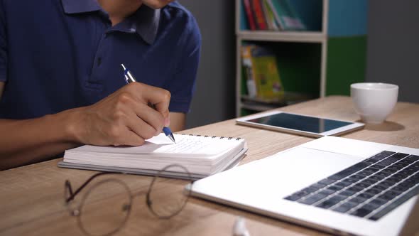 Working With Computer And Note In Book alt