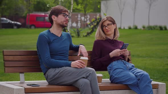 Woman holding phones in hands texting shopping in app checking social media alt