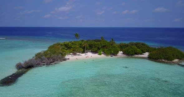 Natural aerial island view of a white sand paradise beach and turquoise sea background in hi res 4K alt