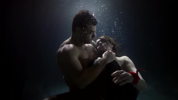 Handsome Man Is Hugging Sexy Woman in Depth of Swimming Pool Lovers Underwater Passion and Love alt