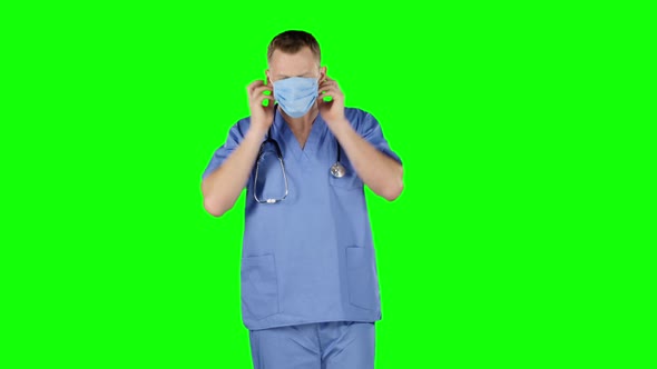 Doctor Puts a Medical Bandage on Face. Green Screen alt