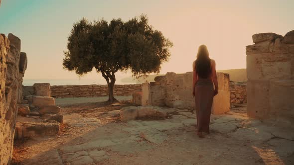 Woman Walking in the Ancient City By the Sea