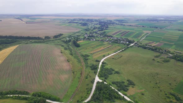 Aerial Above View of Fields and Village House Land Cars Driving on the Road alt