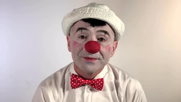 Emoji Clown. A smiling clown mime rejoices and gives one thumb up. (Closeup shot size) alt