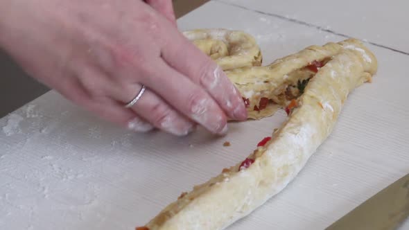 A Woman Prepares A Cruffin With Raisins And Candied Fruits. Rolls The Dough Cruffin. alt