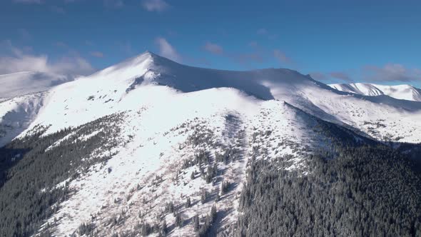 Aerial Panning Shot of Mountain Ridge Covered in Snow