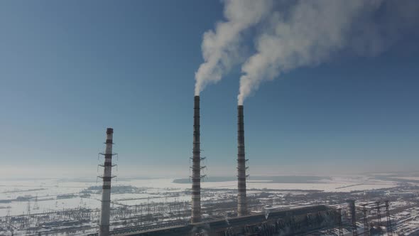 Thermal Power Plant  Smoking Chimneys Various Flights of Red and White Chimney in Winter Frosty Day