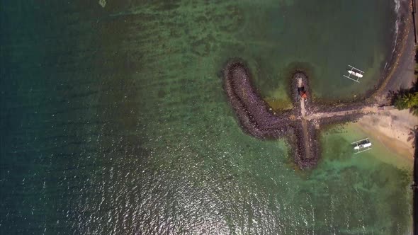 Aerial view of the blue water coast line and pier in Candidasa Beach, Bali, Indonesia alt