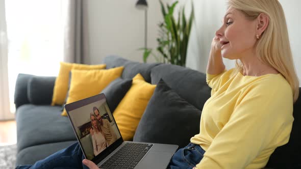 Back View a Senior Woman Using a Laptop for Video Call alt