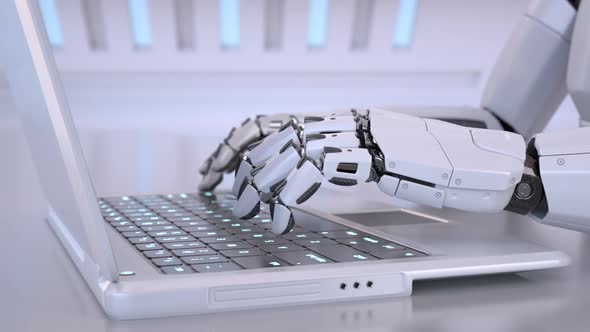 Robots hands typing on a laptop keyboard alt