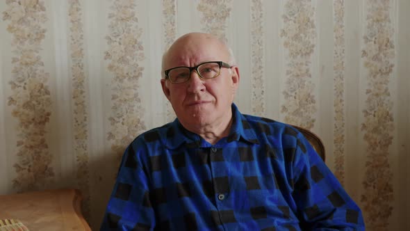 Cute Senior Man Smiling to the Camera Living Room Medium Closeup Senior People Support Concept alt