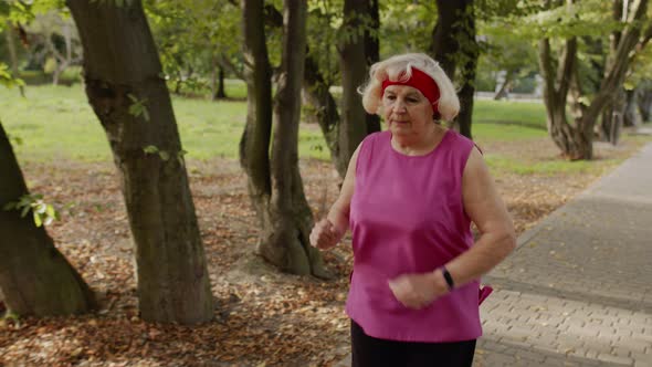 Elderly Sport Runner Woman Training. Workout Cardio in Park. Active Senior People. Fitness alt