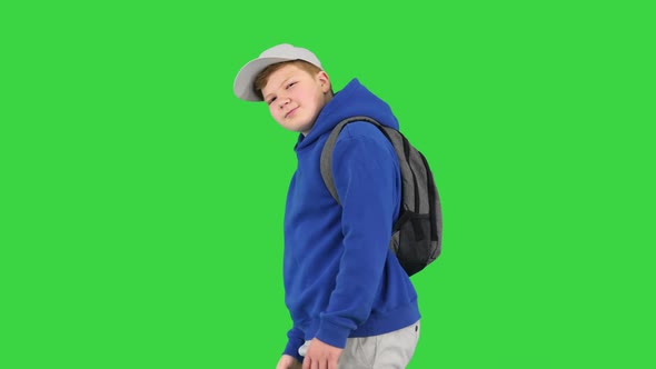 Boy Walking By and Making Hello Gesture To Camera on a Green Screen Chroma Key alt