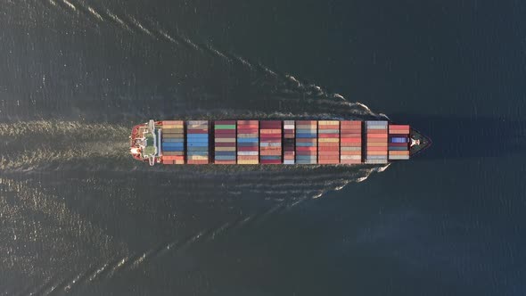 Drone View Vertically Downward on the Movement of the Container Ship at Sea alt