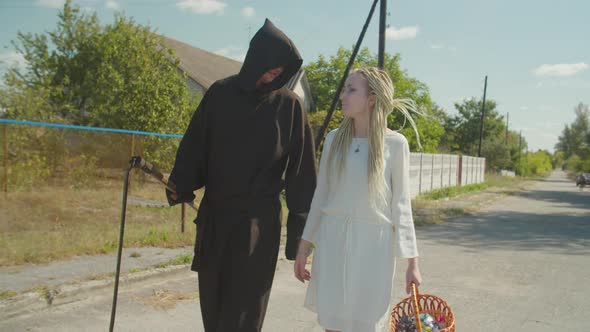 Couple in Halloween Costumes Trick or Treating Outdoors alt