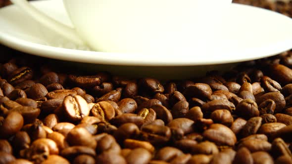Cup with coffee on the background of coffee beans. alt