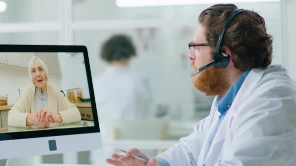 Doctor Consulting Senior Woman via Video Call alt