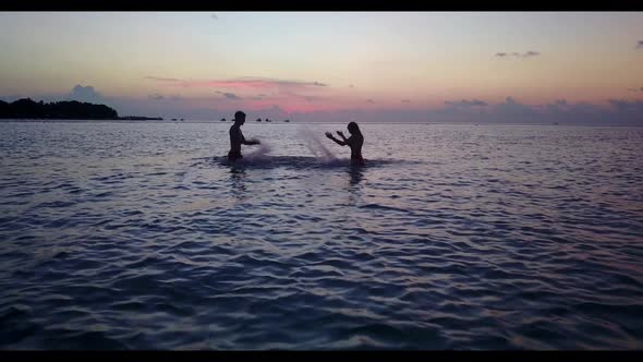 Family of two suntan on tropical sea view beach adventure by blue green ocean with white sandy backg alt