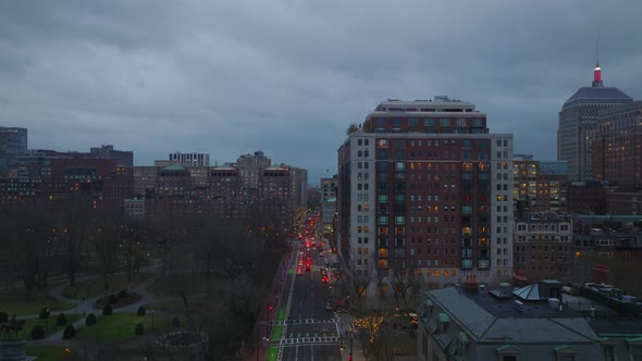 Backwards Fly Above Busy Street in Evening City alt