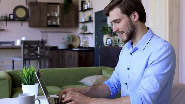 Side view happy young businessman is analizing financial documents from home during self isolation alt