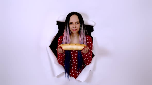 Young Woman Holding White Bread alt