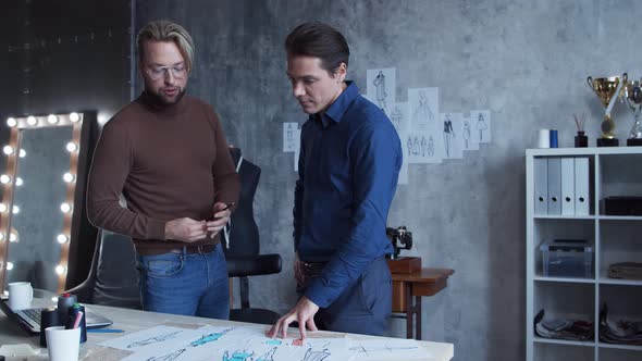 Workplace of young and talented fashion designer. Tailor and his business partner. alt