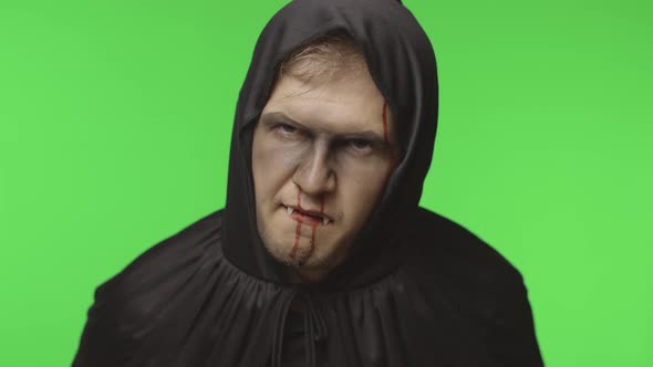 Man Vampire Halloween Makeup and Costume. Guy with Blood on His Face alt