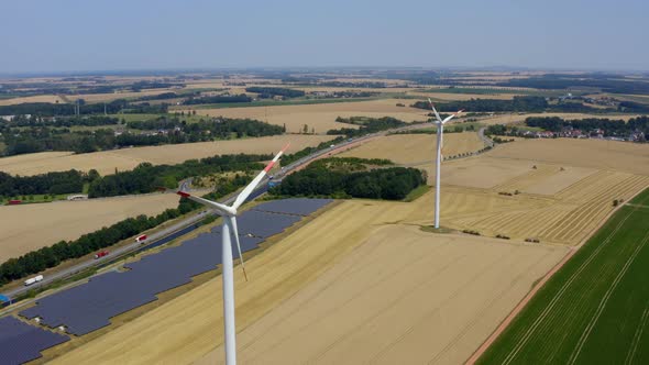 Solar power plant and Windmills aerial view.  alt