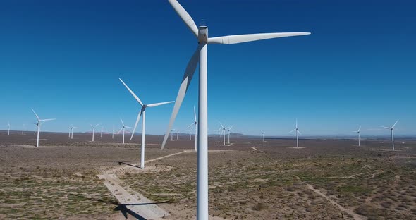 Aerial up and away from wind turbine, desert