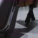 Back View of Female Legs and Suitcase Woman the Runs with a Suitcase Hurrying to Her Flight and - VideoHive Item for Sale