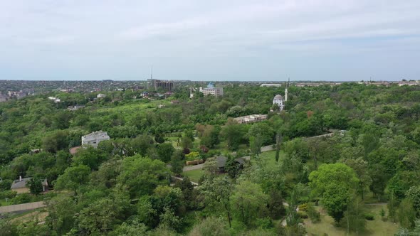 A bird's eye view of the city garden. Among the trees you can see a mosque