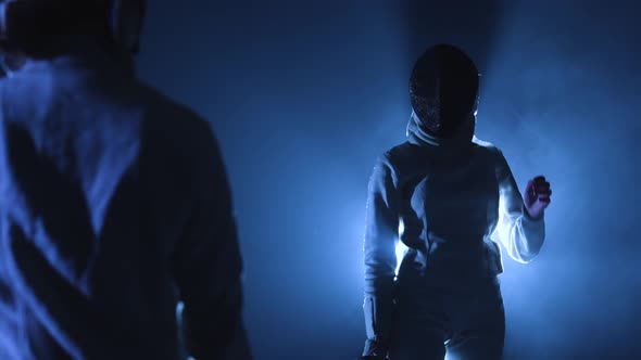 View From Behind on Two Athletes Fencers Competing in Tournament alt