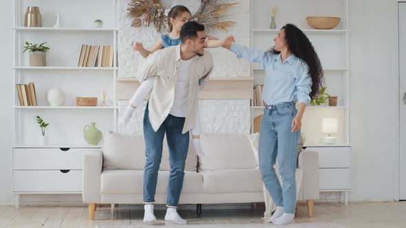Hispanic Family Dancing at Home Living Room with Little Schoolgirl Daughter Celebrating Enjoying alt