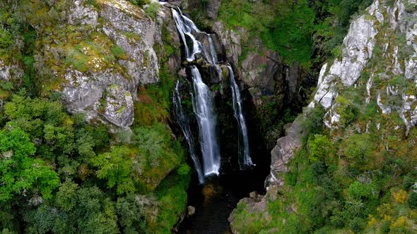 Aerial View Of Fervenza do Toxa Waterfalls Cascading Down Rockface. Pedestal Up alt