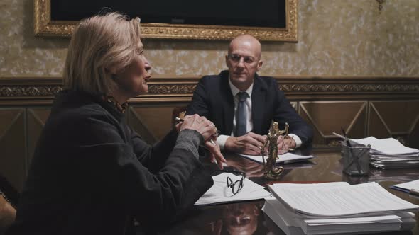 Senior Female Lawyer Speaking with Partners at Meeting alt