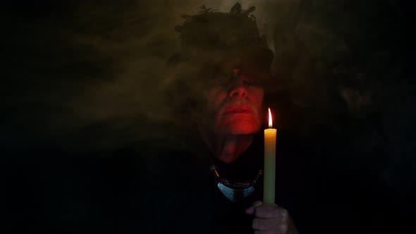 Frightening Creepy Senior Man with Halloween Witcher Makeup Looking at Candle Conjure Hex Wiz alt