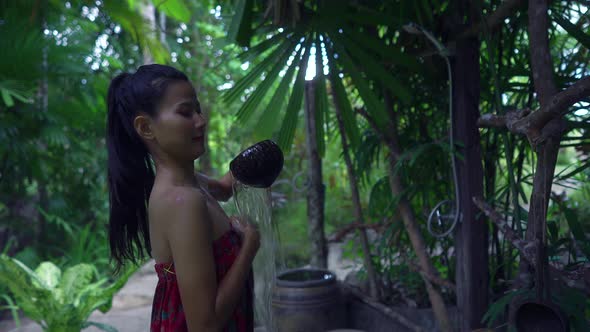 Cute Asian Girl Pouring Water in a Hot Spring in Slow Motion Thailand