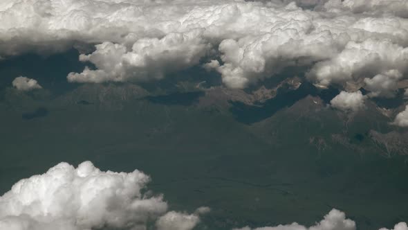 Long Valley Landscape Above Clouds From Airplane Window  alt