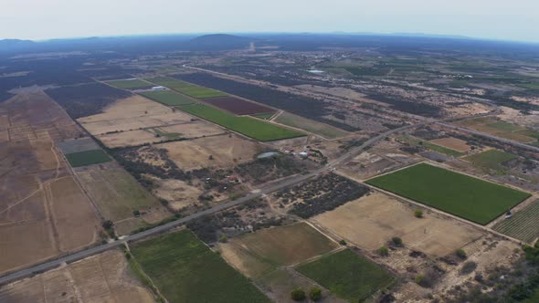 Incredible high altitude aerial view of farm fields and plantations in rural Brazil. alt