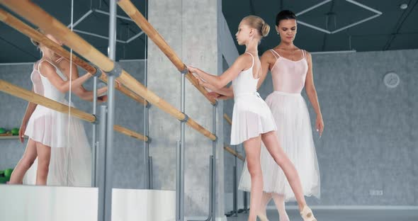 Woman Helps Little Ballerina Do Raise Up Leg alt