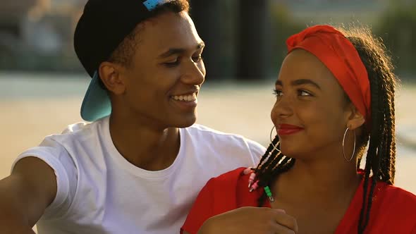 Smiling Teen Couple Hugging and Touching Foreheads, Enjoying Relations Outdoors alt